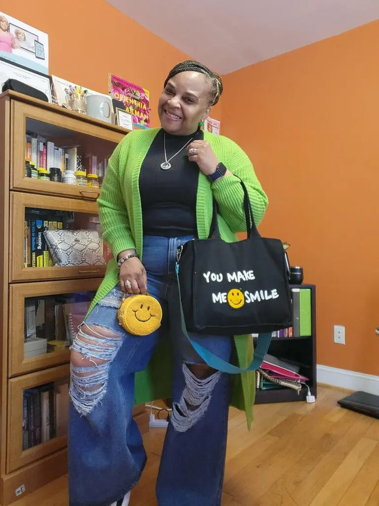 A customer in a library holding a black You Make Me Smile bag